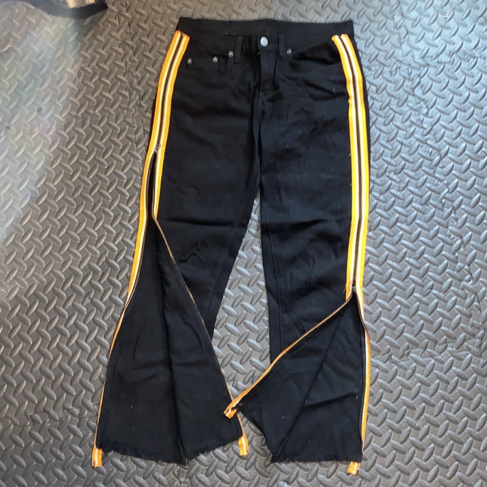 Carmar. Black jeans. SIZE 28. Yellow strip sides that zip all the way to waist.
